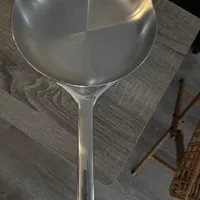 Customer-uploaded image. Click to see more details. The image represents: A stainless steel wok or large frying pan with a long handle sitting on a wooden table surface