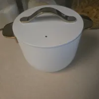 Customer-uploaded image. Click to see more details. The image represents: White ceramic pot with lid and handles on kitchen counter