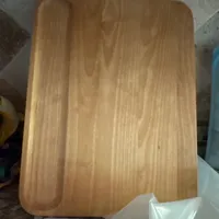 Customer-uploaded image. Click to see more details. The image represents: A wooden cutting board with a groove around the edge, sitting on a tiled surface