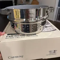 Customer-uploaded image. Click to see more details. The image represents: A stainless steel Caraway 3-quart steamer with perforated insert sitting on its white product packaging box on a kitchen counter