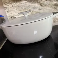 Customer-uploaded image. Click to see more details. The image represents: White ceramic Dutch oven with lid sitting on dark countertop in kitchen