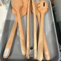 Customer-uploaded image. Click to see more details. The image represents: A set of wooden kitchen utensils including spoons and serving tools arranged in a gray plastic tray