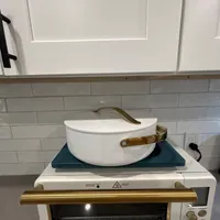 Customer-uploaded image. Click to see more details. The image represents: White kitchen counter with toaster oven, hot plate, and white pot with gold handles stacked on top