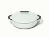 Caraway 3.5 qt enameled cast iron braiser in pale green with a matching lid.