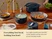 Caraway Navy ceramic cookware serving a meal on a dining table, with vegetables in a fry pan and chicken in a sauté pan.