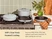 Caraway gray enameled cast iron cookware arranged on a stove and counter.