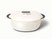 Caraway 8 qt enameled cast iron oval dutch oven in Cream with a matching lid.