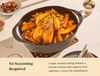 Caraway oval enameled cast iron Dutch oven serving roast chicken and vegetables.