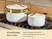 Caraway white ceramic Dutch oven and sauce pan with gold-tone steamer inserts on a stove.