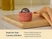 Caraway perracotta mechanical kitchen timer on a wooden cutting board.
