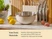 Caraway cream mixing bowl with a stainless steel interior beside glass lids and wooden kitchen tools.
