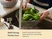 Hands rinsing leafy greens in a stainless steel strainer under running water.