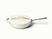 Caraway ceramic sauté pan in Cream with a matching lid.
