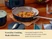 Caraway navy ceramic sauté pan serving chicken on a dining table.