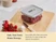 Caraway small glass airtight container with a Gray lid holding red peppers on a cutting board.