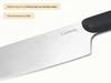 Caraway close-up of a stainless steel kitchen knife blade and Black handle.
