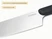 Caraway close-up of a stainless steel kitchen knife blade and Black handle.