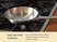 Caraway empty stainless steel mini fry pan on a stove.