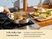 Hand turning food with a wooden utensil in a stainless steel sauté pan on a stove.
