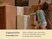 Child closing a light-colored trash can beside a kitchen island.